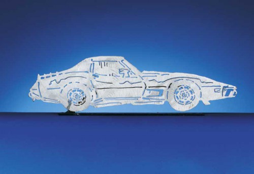 Introducing the 1976 - 1977 C3 Corvette Coupe. Each CarArtWork Corvette sculpture is 17 inches long and is mounted on a flat metal base. The sculpture is securely attached to the base with a single metal rod affixed to the rear of the piece. The mounting rod is positioned so that its appearance is minimized from the front view of the sculpture. Each piece has a brushed metal finish and is coated with clear lacquer to preserve its luster.