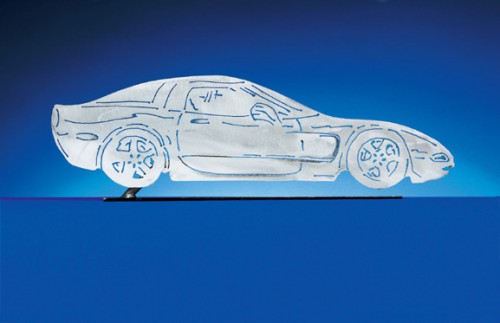 C5 Corvette Coupe Sculpture. Each CarArtWork Corvette sculpture is 17 inches long and is mounted on a flat metal base. The sculpture is securely attached to the base with a single metal rod affixed to the rear of the piece. The mounting rod is positioned so that its appearance is minimized from the front view of the sculpture. Each piece has a brushed metal finish and is coated with clear lacquer to preserve its luster.